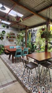 a patio with tables and chairs on a rug at SEMERU HOSTEL MALANG in Malang