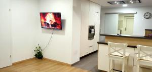 a kitchen with white cabinets and a painting on the wall at 3-Zimmer- Wohnung in Traun, nähe Linz und Wels in Linz