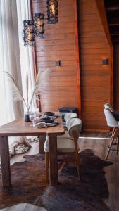 a wooden table with chairs in a room at Vale Aurora Cabanas in Tijucas