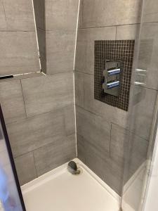 a bathroom with a shower with a glass door at 3 Bedroom Top floor apartment Kensington in London