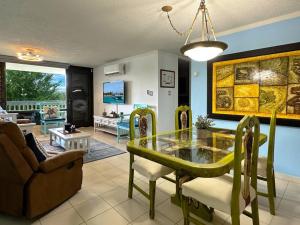 a living room with a glass table and a couch at Marina View Condo 2 Bed / 2 Bath Sleeps 7 in Fajardo