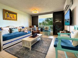 a living room with a couch and a table at Marina View Condo 2 Bed / 2 Bath Sleeps 7 in Fajardo
