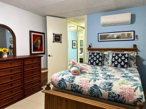 a bedroom with a bed and a dresser at Marina View Condo 2 Bed / 2 Bath Sleeps 7 in Fajardo