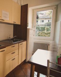 a kitchen with a table and a window at A D R Holiday Home in Casale Corte Cerro