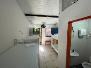 a bathroom with a sink and a room at Ooxe Hostel in Itacaré