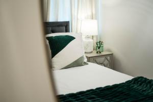 a bedroom with a bed with a pillow and a mirror at Bucks Luxury Apartment - free parking in Buckinghamshire