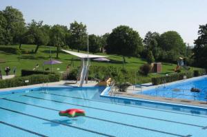 - une grande piscine avec un objet rouge dans l'établissement Streuobst-Action, à Burgbernheim