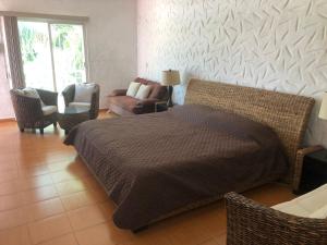 1 dormitorio con cama, sillas y sofá en Hermosa Casa llena de vida, jardín y alberca! en Jiutepec