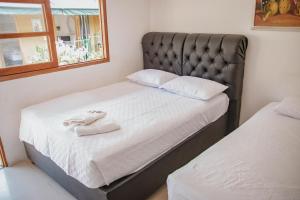 Postel nebo postele na pokoji v ubytování Hotel La Casona de Getsemani