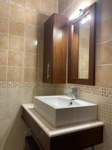 a bathroom with a white sink and a mirror at Nereid Skyros House in Skiros +26 photos