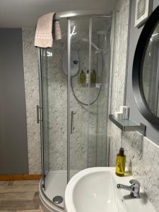 a bathroom with a shower and a sink at Duirinish Pods with Private Hot Tubs and Duirinish Bothy with No Hot Tub in Plockton