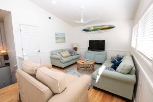 a living room with two couches and a tv at NH301, Driftwood Dreaming- Hot Tub, Oceanside, Close to Ocean! in Nags Head
