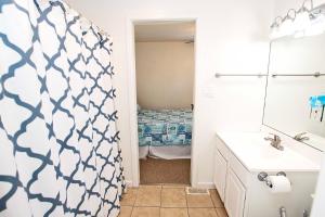 a bathroom with a shower curtain and a sink at Oceanside, Hot Tub, Oceanside, Close to Ocean! NH301, Driftwood Dreaming in Nags Head +33 photos