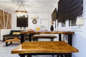 a kitchen and living room with a table and bench at Villa Archontiki I - Private Pool in Vryses