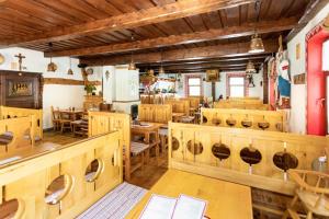 a dining room with wooden tables and chairs at Penzion Koliba in Vysoke Tatry - Tatranska Kotlina