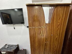 a wooden door with a television on a wall at black pyramids view in Cairo