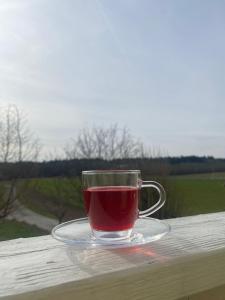 a glass cup of tea sitting on a table at FeWo Giss in Postbauer-Heng