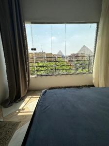 a room with a large window with a view of a city at black pyramids view in Cairo