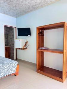 TV a/nebo společenská místnost v ubytování Hotel El Chaman
