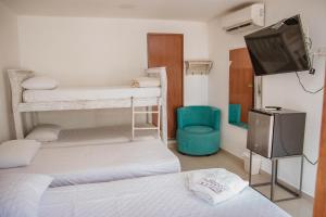 Postel nebo postele na pokoji v ubytování Hotel La Casona de Getsemani