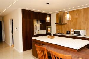 a kitchen with wooden cabinets and a counter top at N3-Brown 1 in Villa Constitución