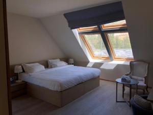 a bedroom with a large bed and a window at Le Grand Chalet Zaarour in Zaarour