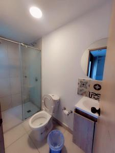 a bathroom with a shower and a toilet and a sink at Aw Hotel Puerta de San Cayetano in Cali