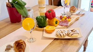 a table with plates of food and glasses of wine at Apartman Leon in Rijeka