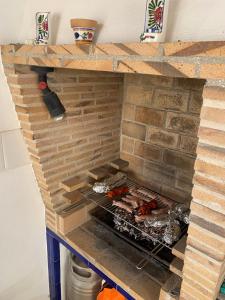 a brick oven with some food cooking in it at Casa Doble Sueno in Orba