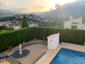 a swimming pool in a backyard with a view of a city at Casa Doble Sueno in Orba
