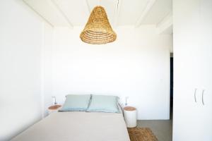 a room with a bed and a pendant light at VILLA AMBROSIA in Khálara