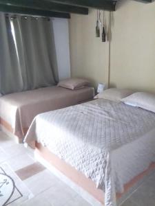 Postel nebo postele na pokoji v ubytování Casa Pueblo Ocú