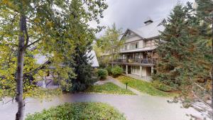 an image of a house that is surrounded by trees at Designer Townhome In Whistler Village with Pool and Hot Tub in Whistler