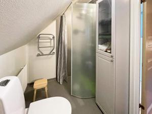 a small bathroom with a toilet and a shower at Holiday home SÖLVESBORG V in Sölvesborg