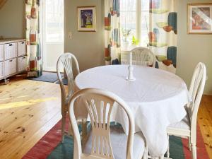 a dining room with a white table and chairs at Holiday home SÖLVESBORG V in Sölvesborg