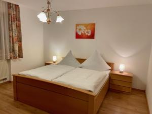 a bedroom with a bed with two lights on it at Ferienwohnungen Pichler in Hohenau