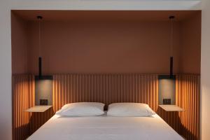 Un pat sau paturi într-o cameră la Palazzo Rizzo