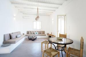 a living room with a table and a couch at VILLA AMBROSIA in Khálara