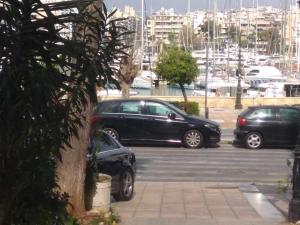 a group of cars parked in a parking lot at Η Ιδανική Κατοικία για Χαλάρωση in Piraeus