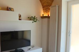 a living room with a large flat screen tv at LA CASETTA DI LULÚ in Rocca San Giovanni