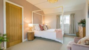 a bedroom with a bed with a large mirror at Penrhyn Isa Un in Aberffraw