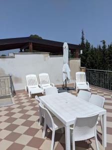 a white table and chairs on a patio at Apartment Difesa Pizzo in Pizzo