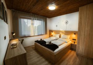 a bedroom with a large bed and a window at Apartmán C1 - Slovenský Raj in Hrabušice