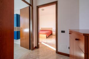 a room with a bed and a door to a bedroom at Rainbow House. Rho Fiera Milano in Rho