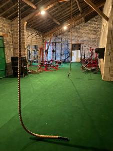 an empty gym with a rope swing at Gite Provençal du Mas Arnaud in Arles