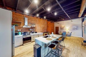a kitchen with a large white island in a room at Broadway Loft in Saint Louis