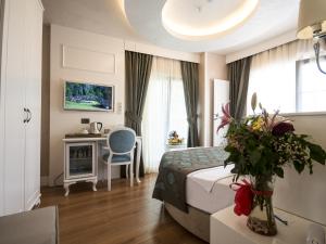 a hotel room with a bed and a desk and a chair at Antusa Palace Hotel & Spa in Istanbul +53 photos