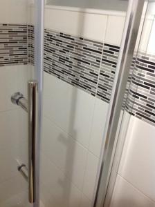 a shower with a glass door in a bathroom at EasyRoom in St Paul's Bay