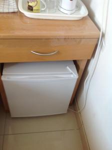 a wooden cabinet with a drawer in a kitchen at EasyRoom in St Paul's Bay