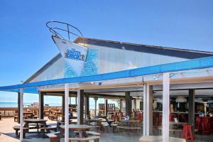 a restaurant with wooden tables and chairs on a deck at Myrtle Beach Resort T1402 in Myrtle Beach